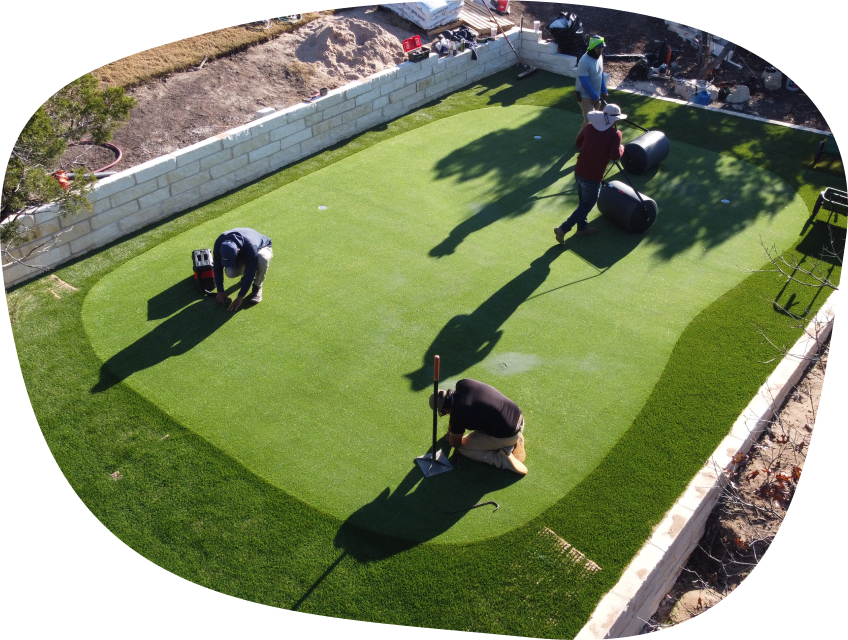 Synthetic grass installation process of application of infill.