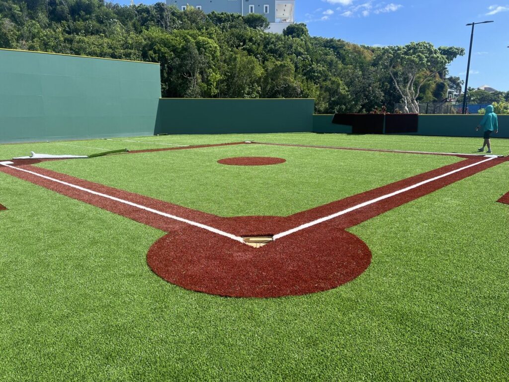 Installing artificial grass wiffle ball field